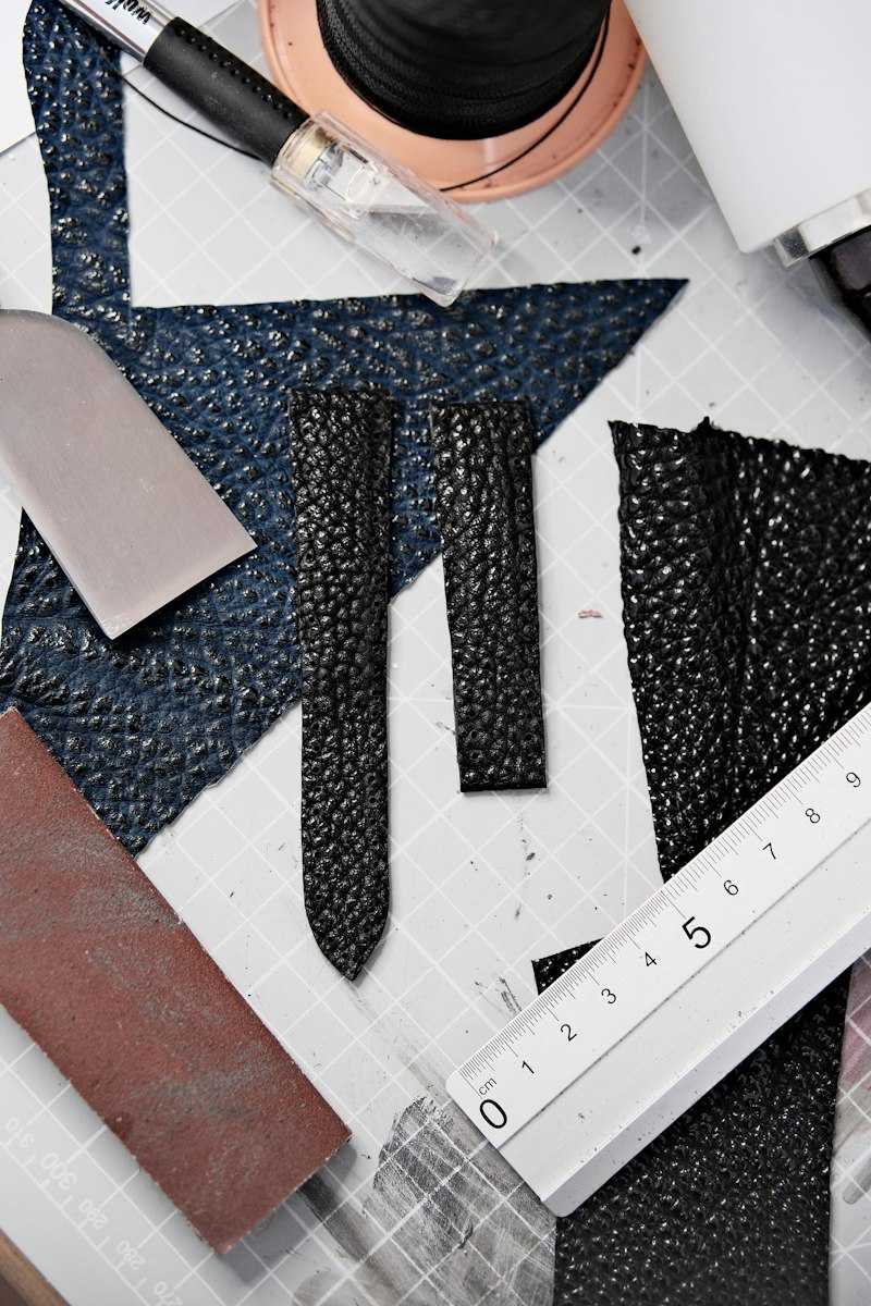 Ruler and scissors on a leather work table